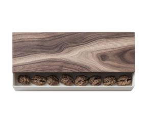 Elegant wooden box containing seven intricately carved stone sculptures artfully displayed on a soft white background