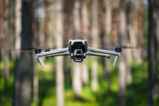 KOTKA, FINLAND - JULY 26, 2025: DJI Air 3S drone in the forest, front view close-up.
