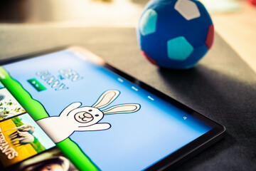 Tablet for kids. Cartoon or video game for child. Watching animated movie or series stream online for children. Playing mobile videogame with pad. Education and learning technology on screen.