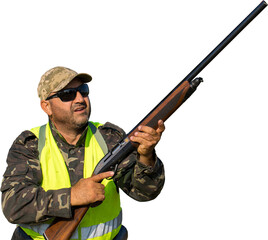 Duck hunter with shotgun walking through a meadow.