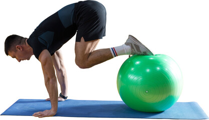 Athletic guy in sportswear and fitness tracker doing exercises in gym.