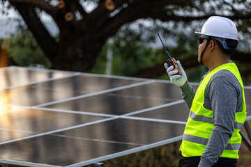Energy Technician with Radio at Installation Site.the supervision and operational aspects of solar...