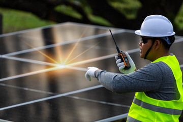 Energy Technician with Radio at Installation Site.the supervision and operational aspects of solar...