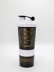 Black and white empty shaker for sports nutrition on white background, healthy nutrition concept