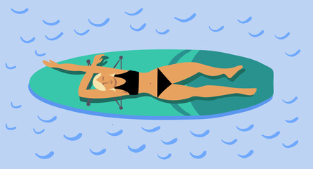 The girl is lying on a paddle board, swimming and relaxing on the water.