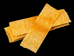 Long chips isolated on black background, rectangular potato snacks, package design element