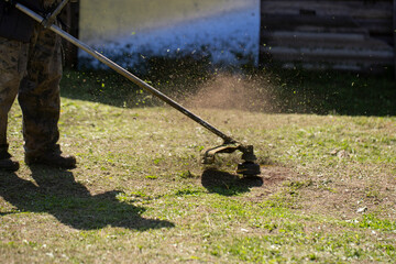 A trimmer for cutting grass and lawns on uneven surfaces.