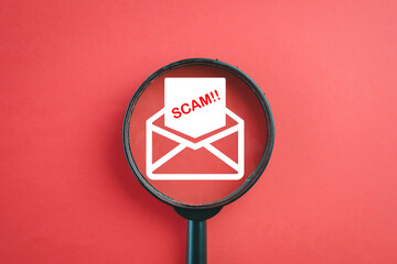 Cybersecurity,Phishing Email Scam concept.,A magnifying glass over an envelope icon with a scam...