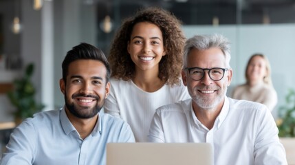 A diverse group of three professionals smiling confidently in an office setting, reflecting teamwork and a positive work environment.