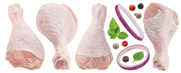 Raw chicken drumsticks with herbs and onion rings isolated on white background
