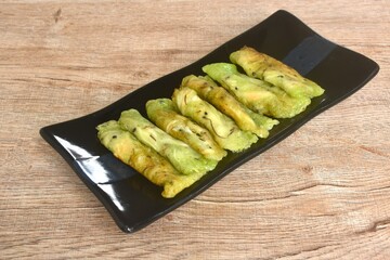 soft fresh coconut crepe topping black sesame Thai sweetmeat arranging on plate