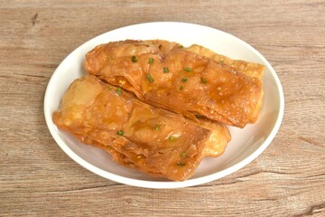 fried crispy sweet southern flat bread or roti dressing sweetened condensed milk on dish