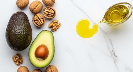 Fresh halved avocado with walnuts and olive oil on white marble surface. Healthy fats, omega-3, ketogenic diet concept. Top view food photography.
