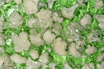Fresh Cauliflower Dropped in Water with Splash Effect Above.