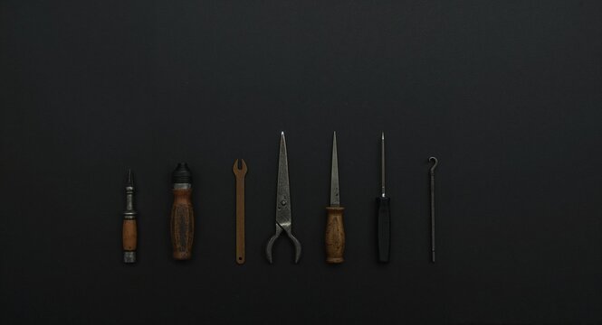 Miniature car repair tools for model kits on plain black background