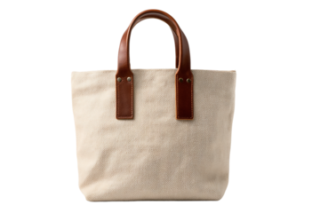 A beige canvas tote bag with brown leather handles is isolated on transparent background, perfect for everyday use and shopping trips