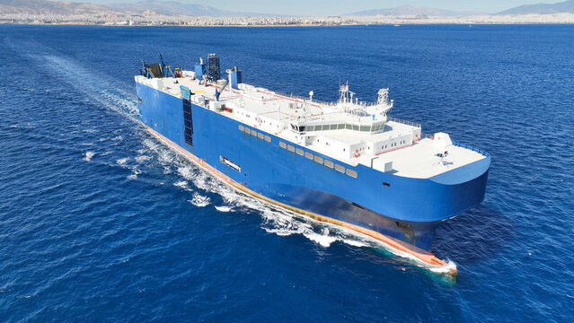 Aerial drone photo of RoRo (Roll on Roll off) vehicle carrier ship cruising in open ocean deep blue sea