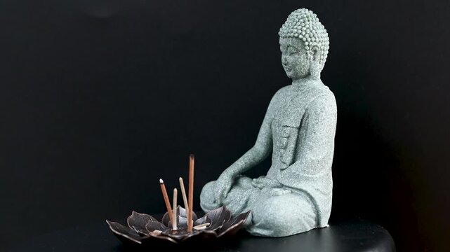 video of buddha statue with incense sticks
