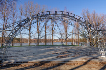 Tent construction for holding summer events on the riverbank on a spring day