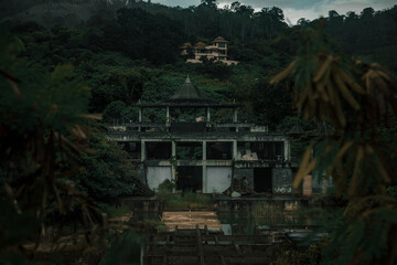 Old abandoned hotel in the jungle. Shabby walls. Beautiful abandoned hotel.