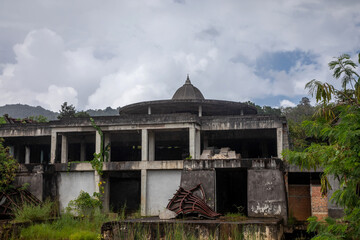 Old abandoned hotel in the jungle. Shabby walls. Beautiful abandoned hotel.
