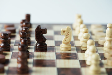 The confrontation between chess brown horse and white horse. Chess pieces in chess board games for...