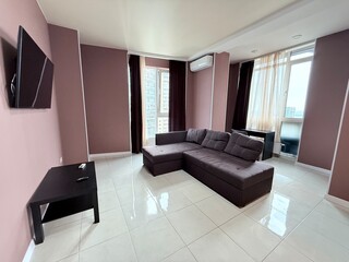 Spacious living room with corner sofa and panoramic windows