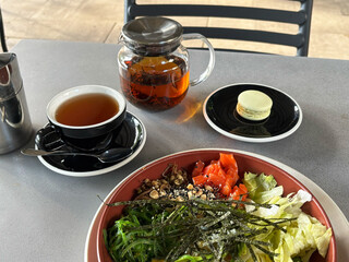 Teapot cup of tea dessert on a served table in a cafe. The atmosphere is cozy and welcoming