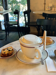 Teapot cup of tea dessert on a served table in a cafe. The atmosphere is cozy and welcoming