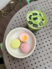 Iced green tea matcha tonic latte and macaroon dessert. Cold drinks and sweets.