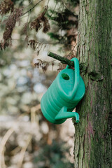 green watering can on the tree