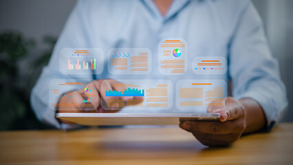 Data analytics concept with businessman using tablet to analyze digital report and charts. Business...