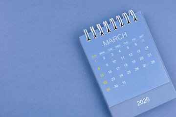March 2026 calendar on blue color background. Desk calendar for planning and organizing.