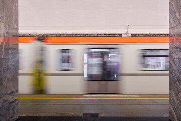 The dynamic and vibrant motion of a subway train while at an urban station is remarkable