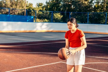 joyful teenage girl with ball on court, casual outfit, after school recreation time