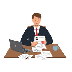 Man at desk with laptop reviewing resumes