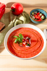 Fresh tomato and bell pepper gazpacho with basil and onion — overhead, natural light.CR2+JPEG
