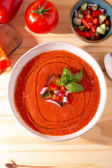 Fresh tomato and bell pepper gazpacho with basil and onion &mdash; overhead, natural light.CR2+JPEG