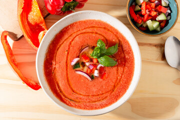 Fresh tomato and bell pepper gazpacho with basil and onion &mdash; overhead, natural light.CR2+JPEG