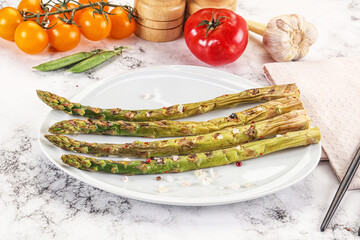 Grilled asparagus sprouts served red pepper