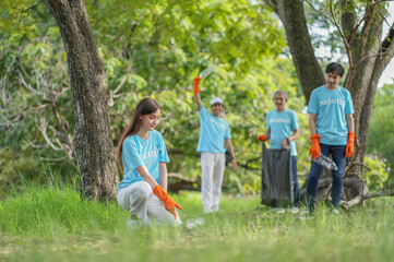 portrait young caucasian woman picking up used plastic bottle on ground with background diverse...