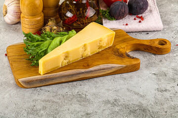 Hard parmesan cheese triangle over board