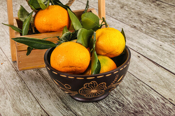 Ripe sweet tangerines heap with leaves