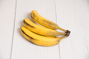 A branch of spoiled bananas on light background