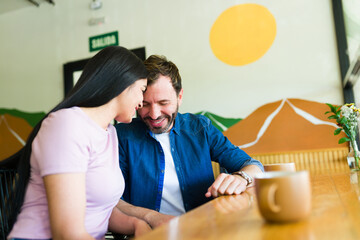 Happy couple enjoying a romantic date at coffee shop