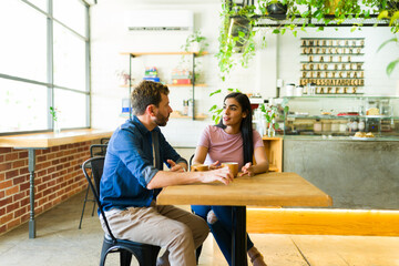 Couple talking and drinking coffee in a cafe