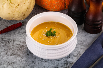 Vegan pumpkin cream soup served sesam