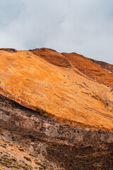 A volcanic landscape with desert and rocky mountains.