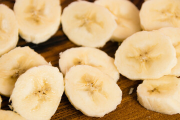 Banana slices on a dark wooden background