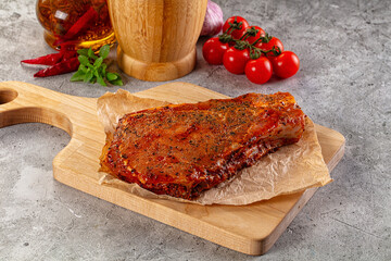Raw marinated pork loin steak